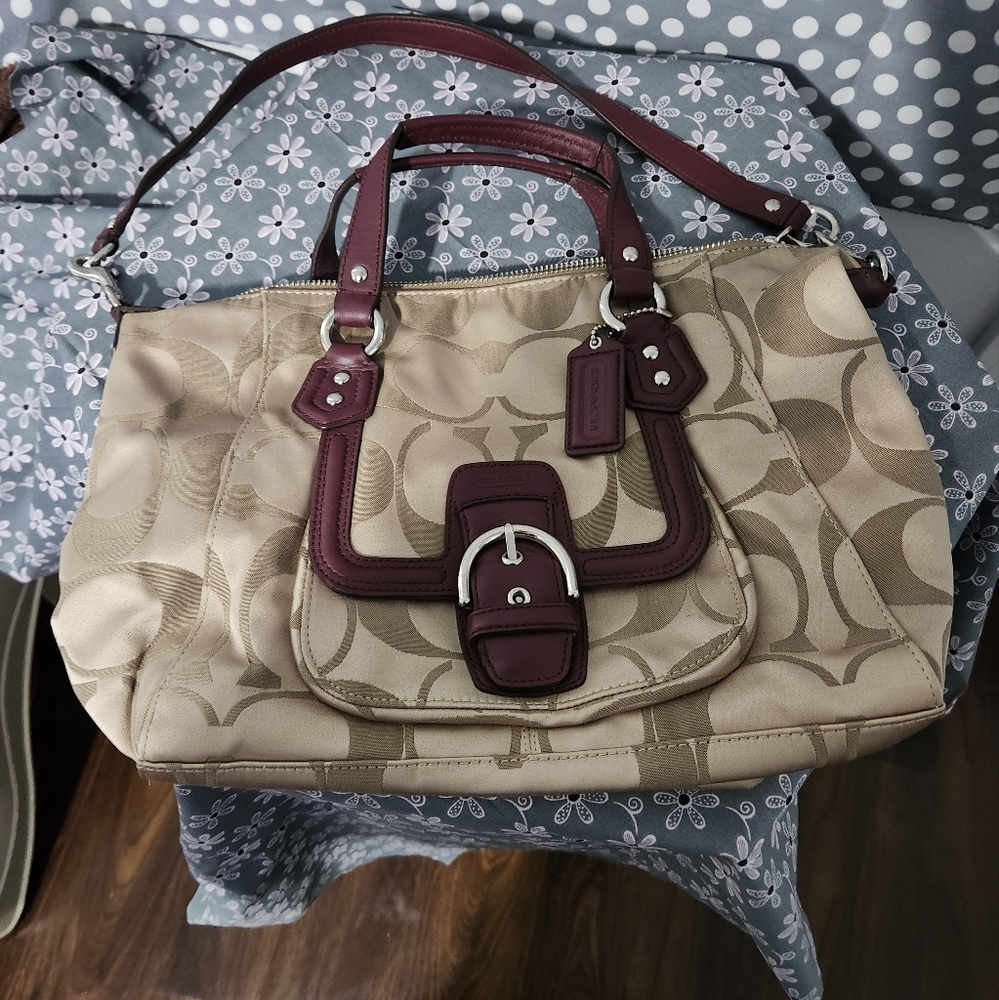 Coach handbag with handles and strap.